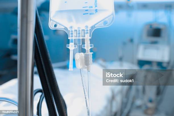 Intravenous Drip On The Background Of Patient Under The Heart Monitoring Stock Photo - Download Image Now