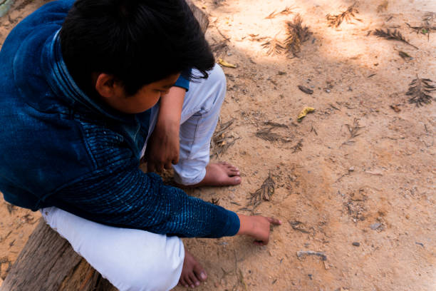istock sad teenager boy sitting alone looking down 1148594125