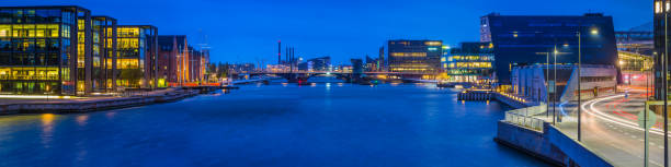istock Copenhagen harbour modern developments warehouses illuminated at dusk panorma Denmark 1148594383