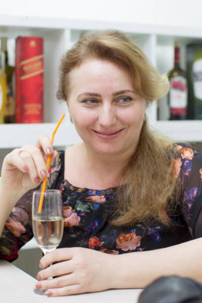 istock Woman drinking alcoholic cocktail from a straw 1148595342