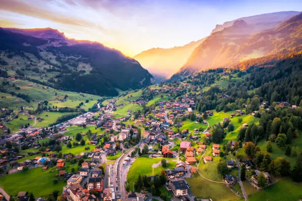 Panoramic view of Swiss village of Grindelwald at dusk with dramatic sunset color