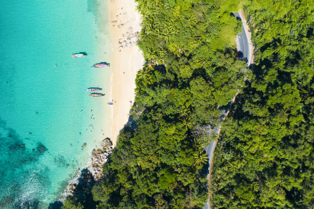 view from above, stunning aerial view of a beautiful tropical beach with white sand and turquoise clear water, long tail boats and people sunbathing, banana beach, phuket, thailand. - 5105 imagens e fotografias de stock