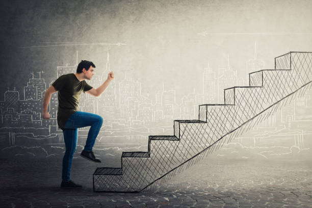 istock Motivated and confident young man hurry to climb a imaginative staircase 1148599604