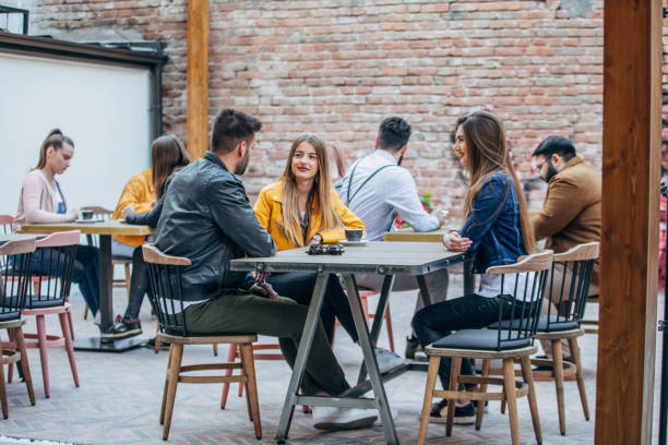 istock Group of young joyful friends having fun in a pub 1148602181