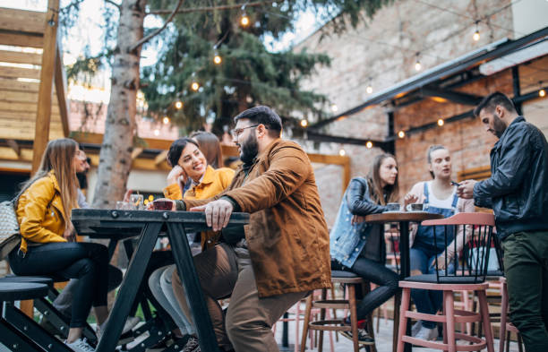 istock Group of young joyful friends having fun in a pub 1148602216