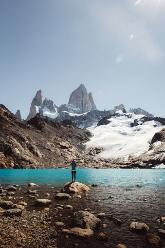 Young woman enjoying a day at Argentinian Patagonia - hiking to Fitz Roy mountain and lagoon De Los Tres during bright warm summer day