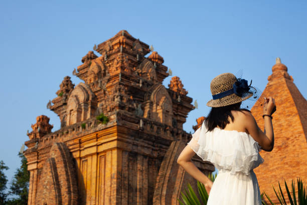 asian woman is taking photo near Po Nagar Cham towers, April,15,2019 Nha Trang, Vietnam