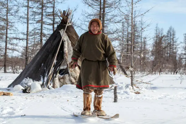 Residents of the far north,  the pasture of Nenets people, the dwelling of the peoples of the north of Yamal,Hunter on self-made skiing in the tundra