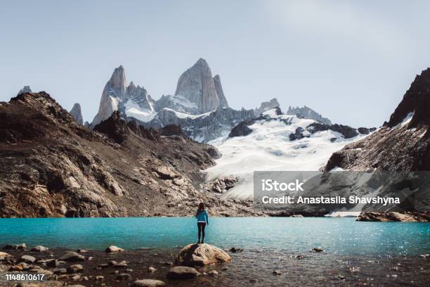 Woman Looking At Fitz Roy Mountain And Turquoise Lagoon In El Chalten Argentina Stock Photo - Download Image Now