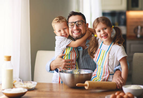 istock father with children   baking cookies 1148612732