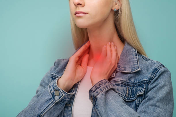 A young girl has a sore throat. Thyroid problems A young girl has a sore throat. Thyroid problems - Image lymph node photos stock pictures, royalty-free photos & images