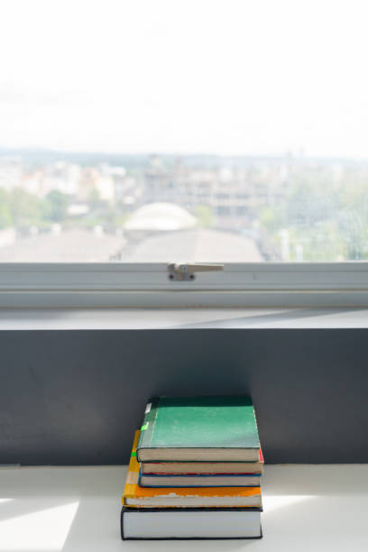 istock books stacked on the table at the university library in selective focus. 1148615483