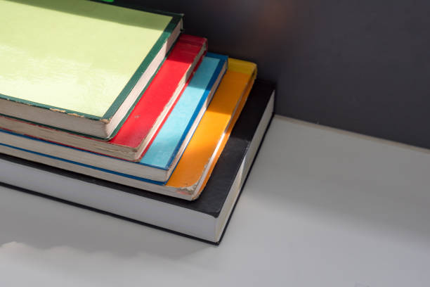 istock Close up books stacked on the table at the university library in selective focus. 1148615555