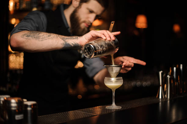 istock Bartender prepares an alcohol cocktail using shaker and sieve 1148615779