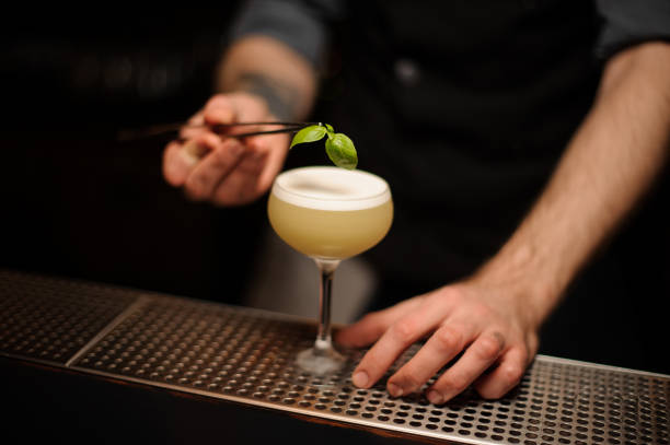 istock Close shot of a bartender pouring cocktail using forceps 1148615965