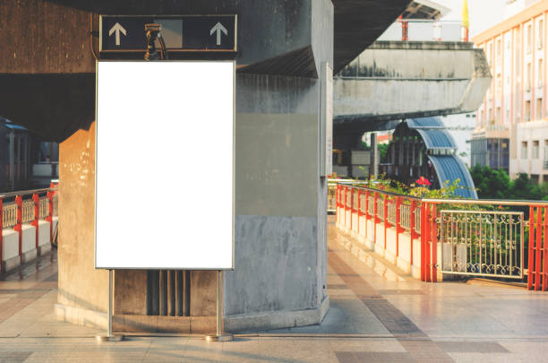 istock announcement billboard big blank white LED screen perspective vertical outstanding on skytrain platform side pathway to railway for display advertisement text template promotion new brand outdoor. 1148617098