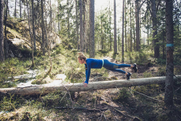 istock Fitness woman in plank position on the tree. 1148617547