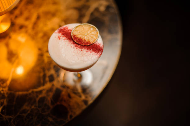 istock Close-up of alcohol cocktail on a table with lamp 1148617713