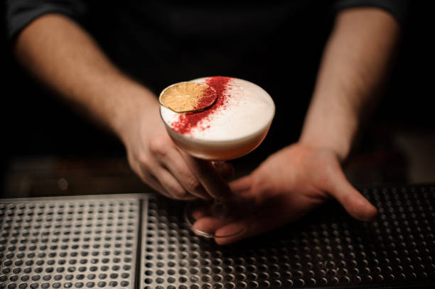 istock Close-up of bartender holding alcohol cocktail in his hands 1148618148