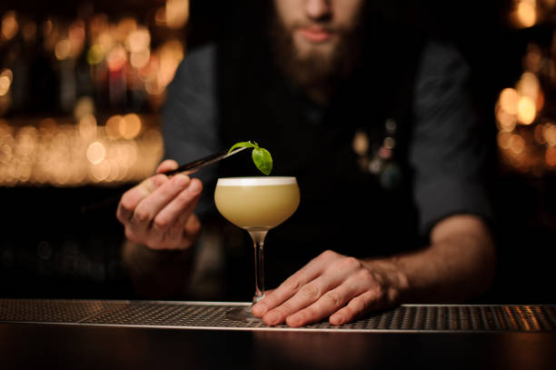 istock Close-up of bartender pouring cocktail using forceps 1148618799