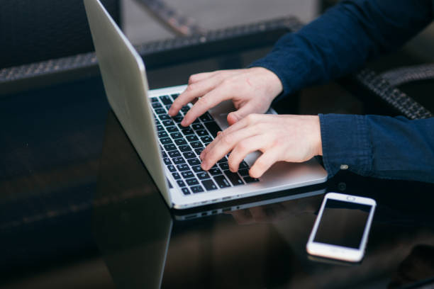 istock Mid selection of man using laptop and put finger on button 1148618827
