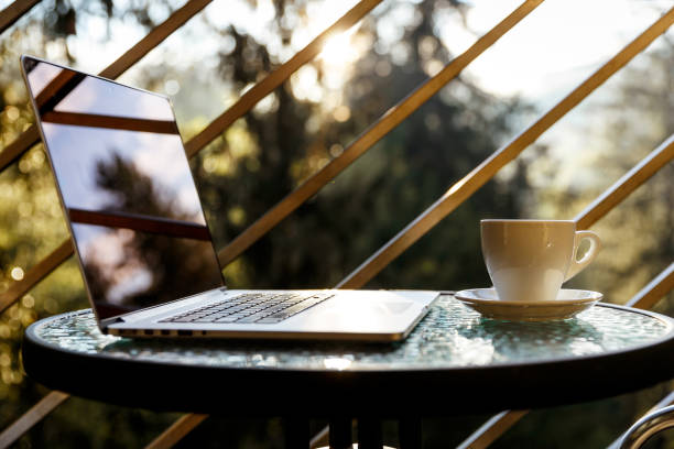 istock White tea or coffee mug and a laptop on a balcony coffee table 1148619677