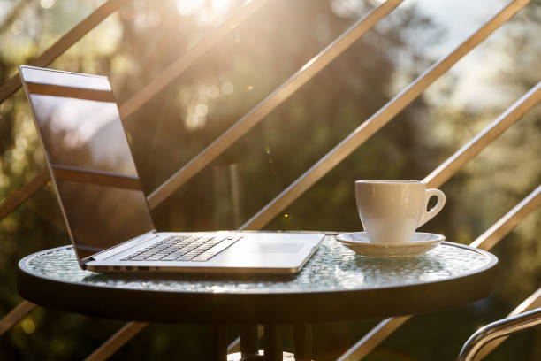 istock White tea or coffee mug and a laptop on a balcony coffee table 1148619850