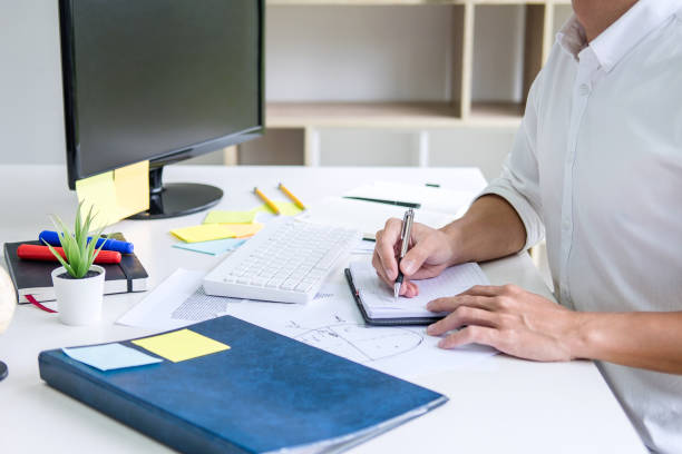 istock Businessman working writing making note business plan and graphic designer with computer in office 1148622097