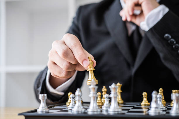 istock Hands of confident businessman playing chess game to development analysis new strategy plan, leader and teamwork concept for win and success 1148622143