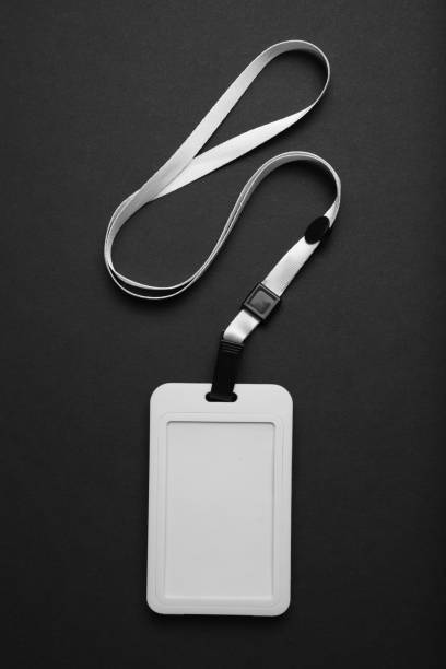 istock Blank badge mockup on black background. Plain empty name tag mock up hanging on neck with string 1148622433