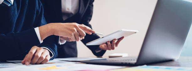 istock Business team using tablet and laptop computer to work in the office. proportion of the banner for ads. 1148623962