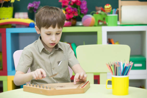 istock A child with a musical instrument. Boy learn to play dulcimer 1148624014