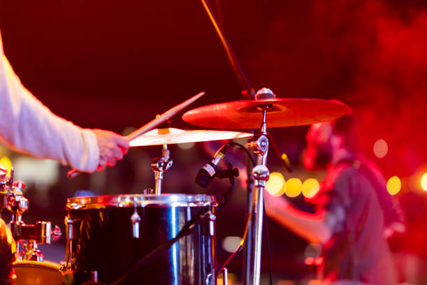 Drummer playing drums on stage Drummer playing drums on stage bass drum photos stock pictures, royalty-free photos & images