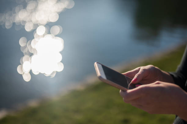 Woman texting outdoors, Nikon Z7
