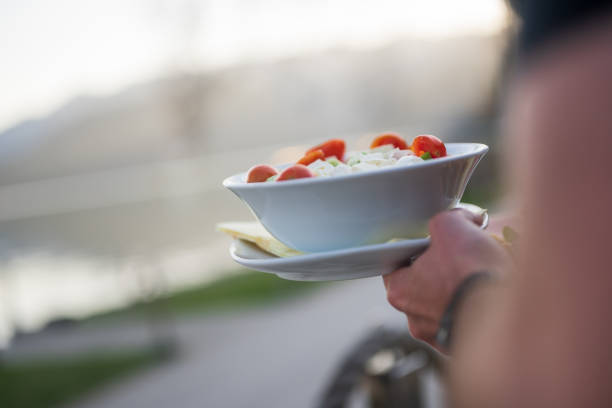 Unrecognizable waiter carrying fresh salad, Nikon Z7