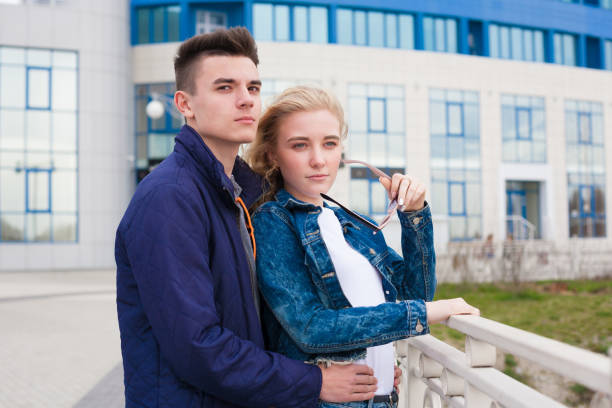 istock Girl and boy, jeans jacket, fun, close up 1148629385