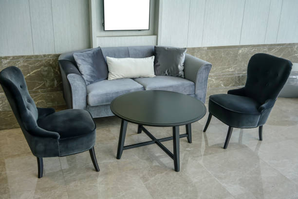 istock Home interior with black circle table, black chairs and gray sofa. Interior detail design 1148631385