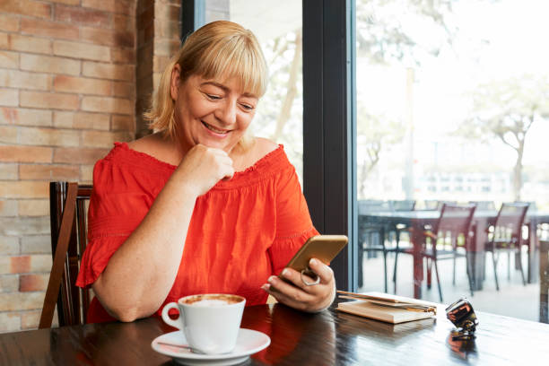 istock Happy woman checking her phone 1148632154