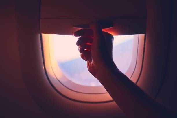 istock Close-up airplane window at sunrise 1148632330
