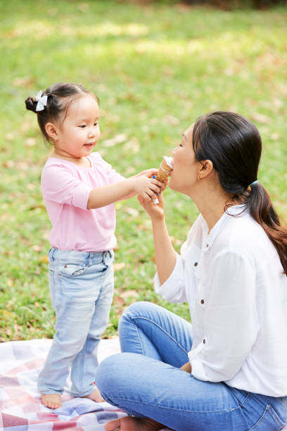 istock Daughter sharing ice cream with mother 1148633721
