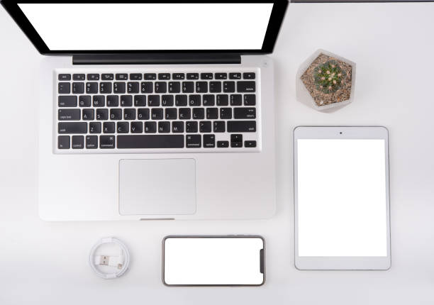 istock office tabletop with tablet, smartphone and laptop isolated on white background 1148633985