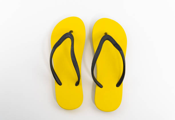 istock yellow flip flops isolated on white background. Top view 1148634000