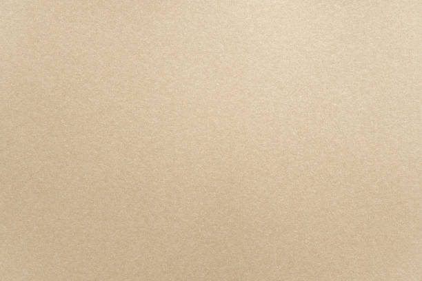 Abstract beige glossy paper texture background or backdrop. Empty light brown cardboard or shiny paperboard for decorative design element. Simple grainy surface for journal template presentation