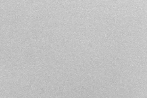 Abstract grey glossy paper texture background or backdrop. Empty gray cardboard or shiny paperboard for decorative design element. Simple grainy textured surface for journal template presentation