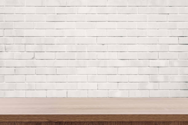 istock white brick wall and wooden table with copy space, display montage for product 1148636306