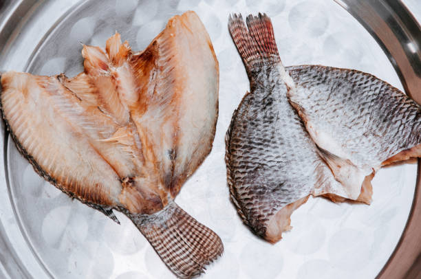 istock Couple Sun dried salted Tilapia fish on stainless tray 1148637482