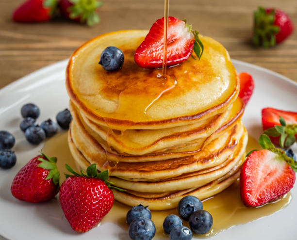 Sunday breakfast Pancakes with blueberries and strawberries. pancake stock pictures, royalty-free photos & images