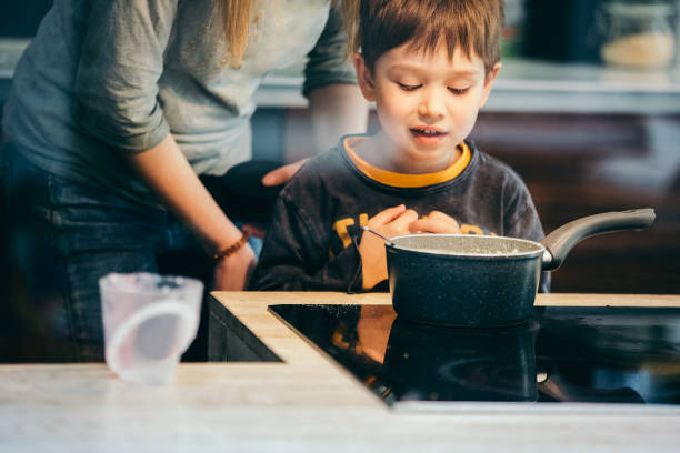 istock Boy helping his mom in the kitchen 1148639634