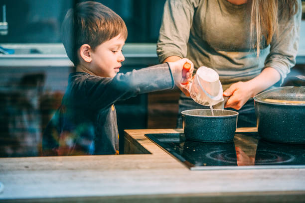 istock Boy helping his mom in the kitchen 1148639783
