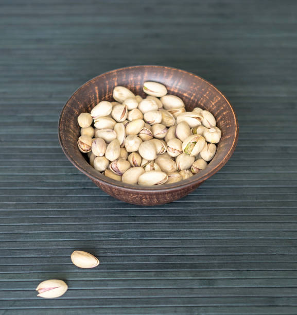 Healthy food  for background image close up pistachios nuts. Texture on top view Nuts pistachio on the cup plate